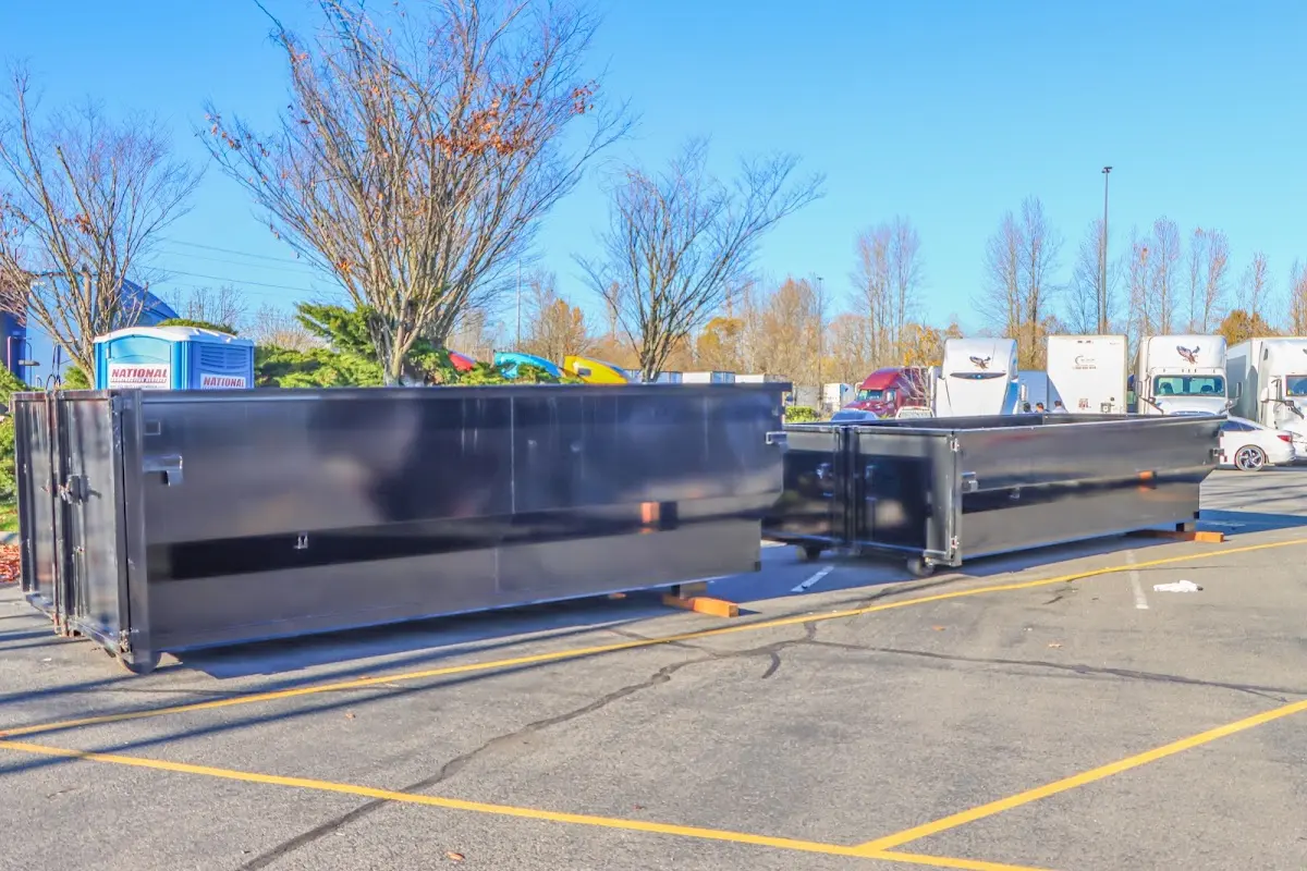 Professional dumpster rental service with roll-off container on residential driveway in Bluffton